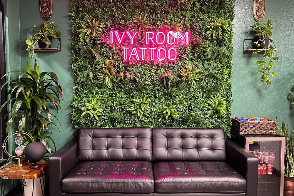 Ivy Room Tattoo shop interior with neon sign and seating